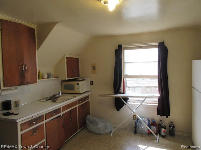 kitchen with vaulted ceiling and sink