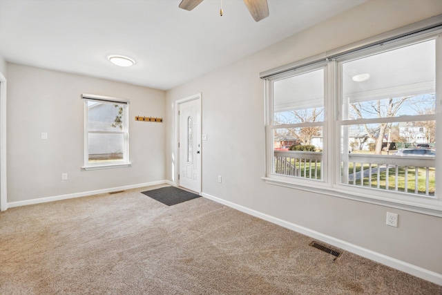 interior space with ceiling fan and a wealth of natural light