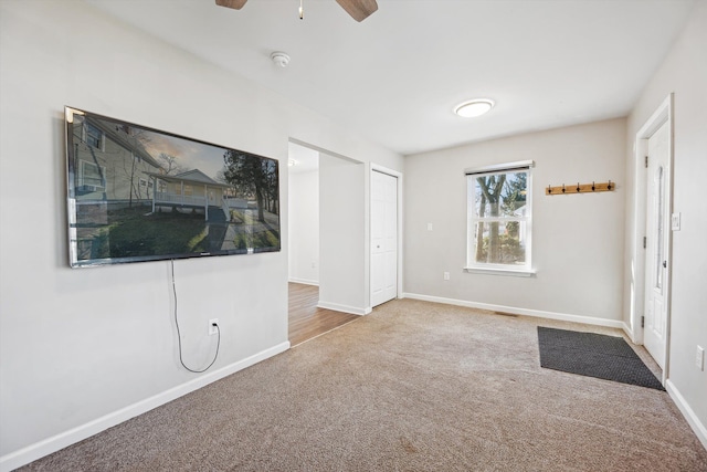 interior space featuring ceiling fan and carpet floors