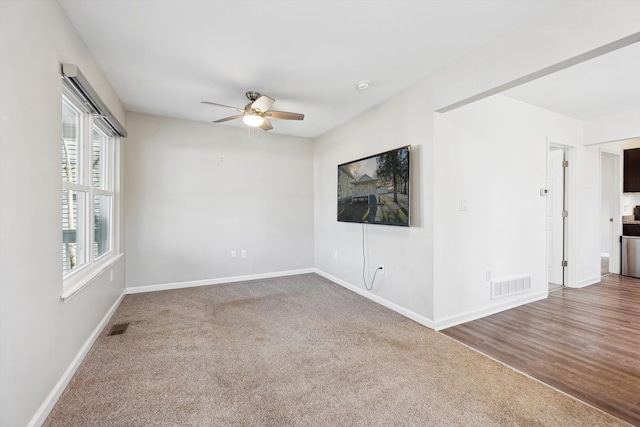 unfurnished room featuring ceiling fan and carpet floors