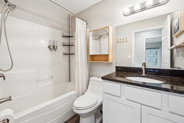 full bathroom featuring shower / bath combination with curtain, toilet, and vanity