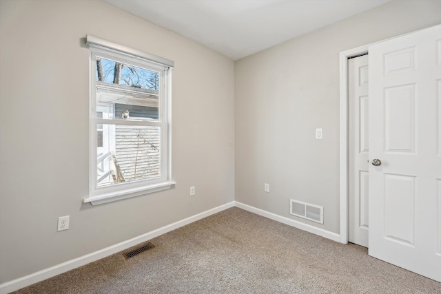 unfurnished room with carpet and plenty of natural light