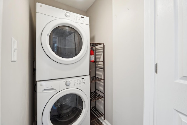 laundry area featuring stacked washer / drying machine