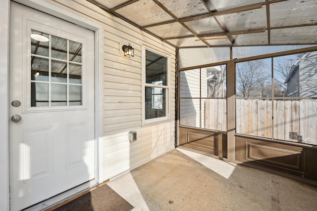 unfurnished sunroom with vaulted ceiling