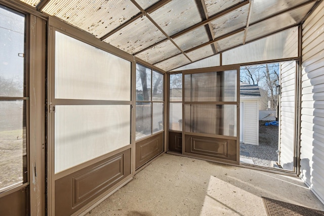 unfurnished sunroom with lofted ceiling