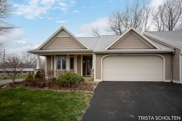 view of front of house with a porch and a garage