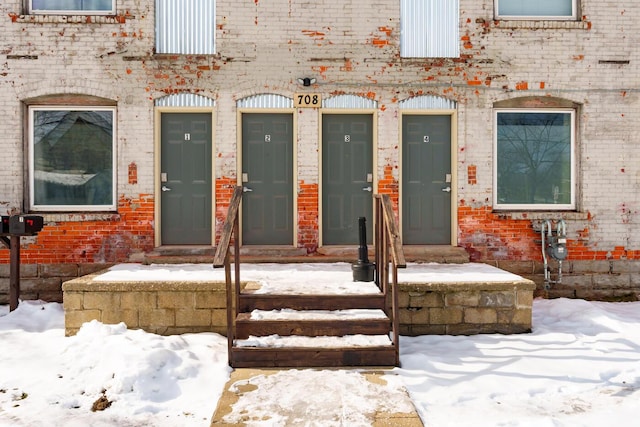 view of snow covered property entrance