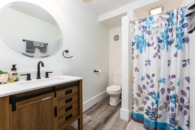 bathroom with hardwood / wood-style floors, vanity, toilet, and a shower with curtain