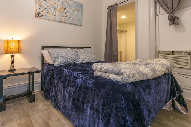 bedroom featuring hardwood / wood-style floors and cooling unit