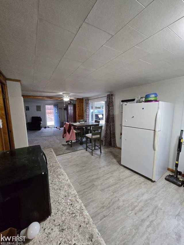 dining area with ceiling fan and light wood-type flooring