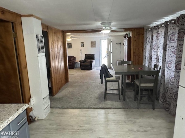 dining room featuring ceiling fan and light carpet