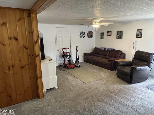 carpeted living room with beam ceiling, a textured ceiling, and ceiling fan