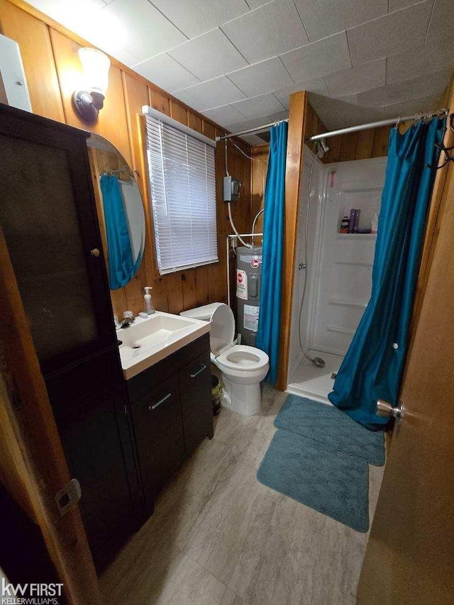 bathroom featuring curtained shower, water heater, toilet, wooden walls, and vanity