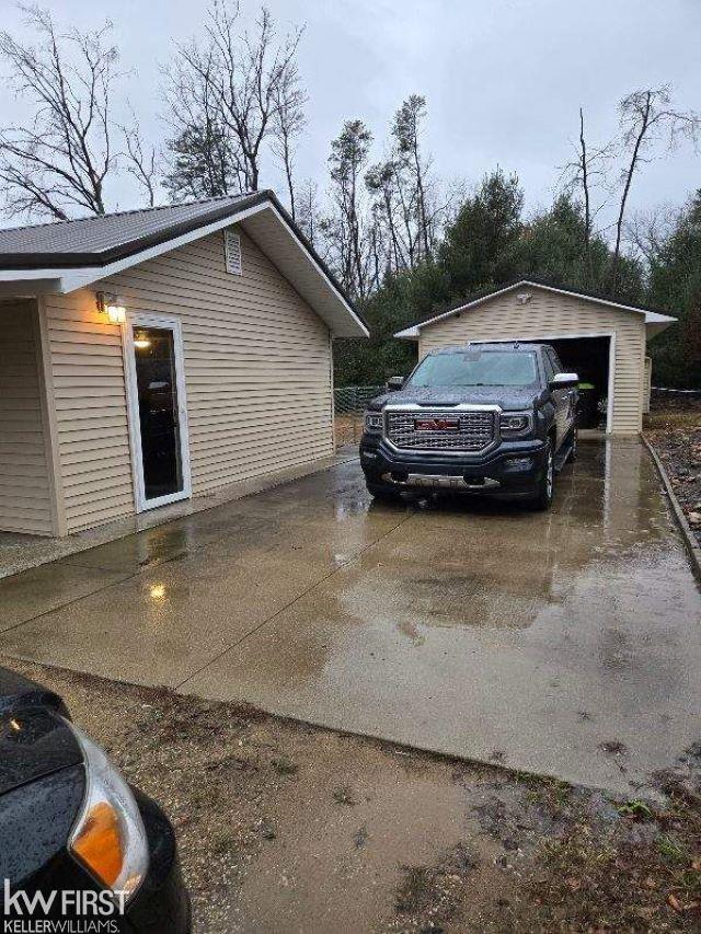 view of home's exterior featuring a garage and an outdoor structure