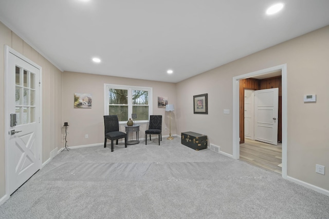 living area featuring light colored carpet