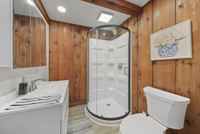 bathroom featuring beam ceiling, vanity, and wood walls