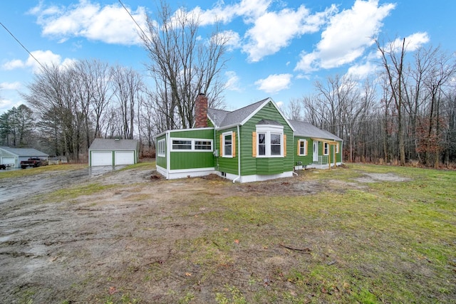 view of home's exterior featuring a lawn, an outbuilding, and a garage