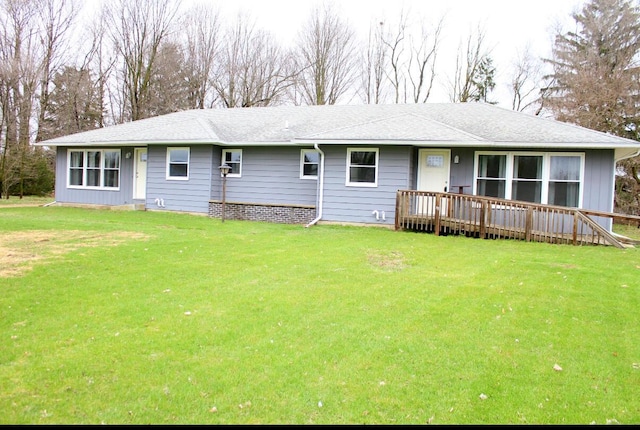 view of front facade featuring a wooden deck and a front lawn