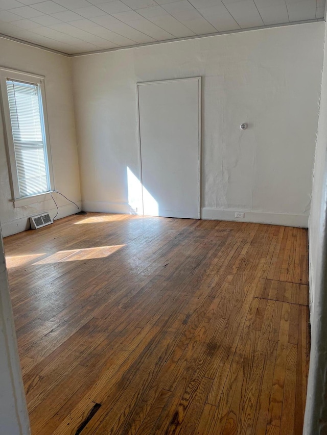 empty room featuring wood-type flooring