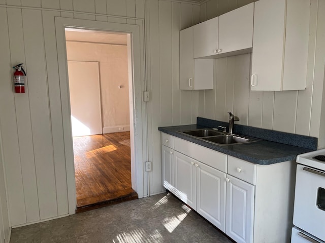 kitchen with sink, white cabinets, and white electric range oven