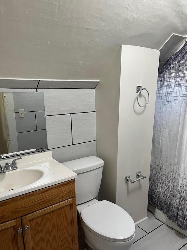 bathroom with tile patterned floors, vanity, and toilet