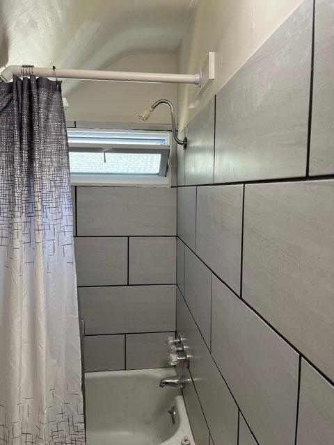 bathroom featuring shower / bath combination with curtain