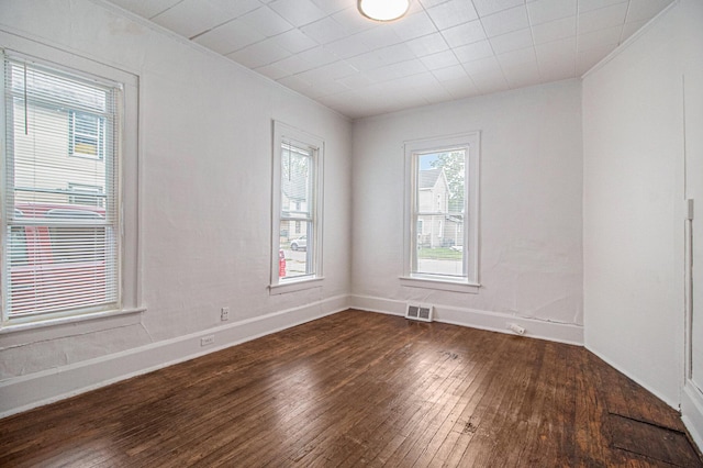 empty room with dark hardwood / wood-style flooring