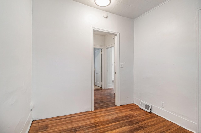 unfurnished room featuring dark wood-type flooring