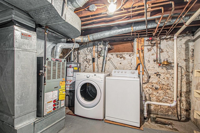 laundry area featuring heating unit, separate washer and dryer, and water heater