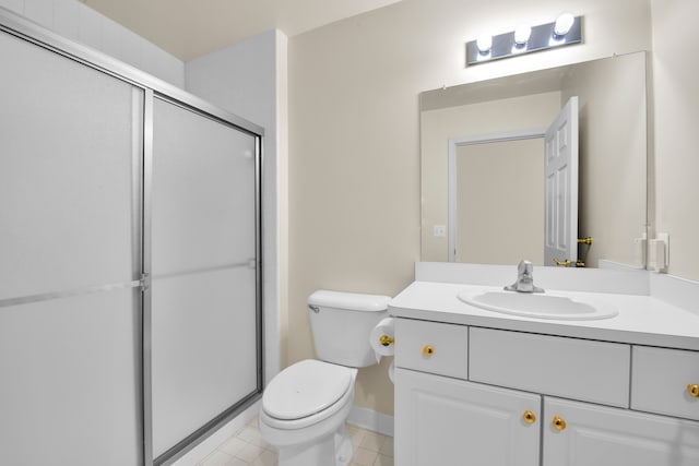 bathroom featuring vanity, tile patterned flooring, a shower with shower door, and toilet