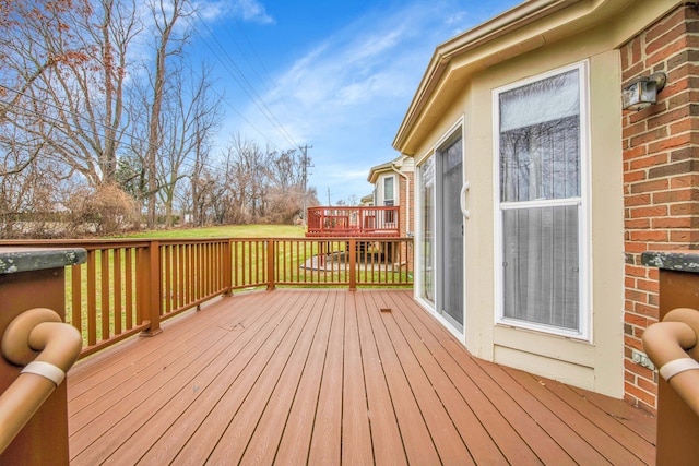 wooden terrace with a yard