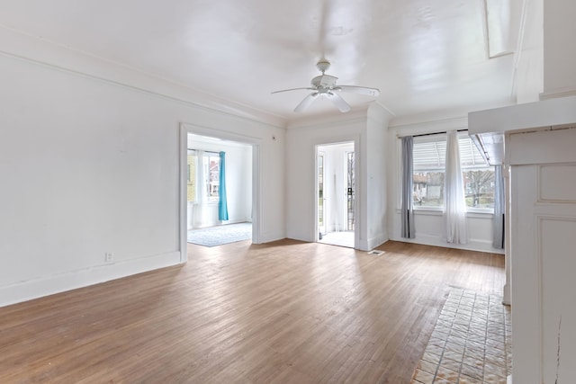 unfurnished living room featuring light hardwood / wood-style flooring, ceiling fan, and ornamental molding