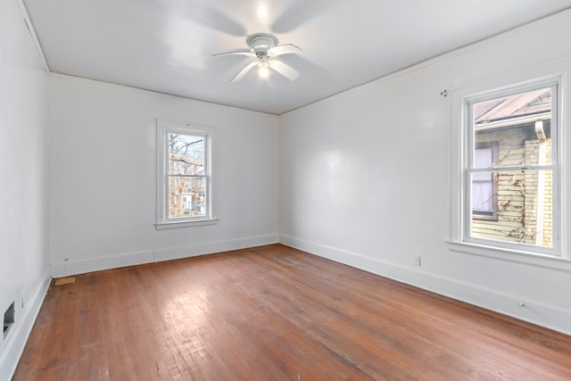 unfurnished room featuring hardwood / wood-style flooring, ceiling fan, and crown molding