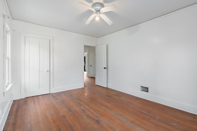 unfurnished bedroom featuring dark hardwood / wood-style flooring, a closet, and ceiling fan