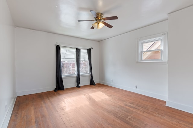 empty room featuring ceiling fan and light hardwood / wood-style floors