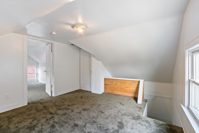 bonus room with carpet floors and vaulted ceiling