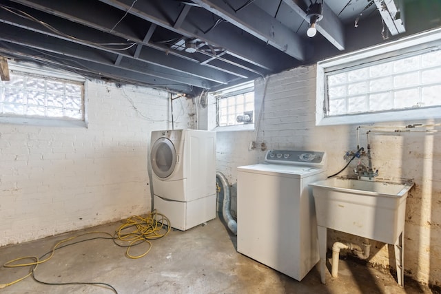 washroom with washer and clothes dryer and sink