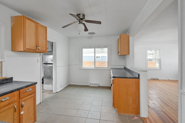 kitchen featuring plenty of natural light, ceiling fan, and light tile patterned flooring