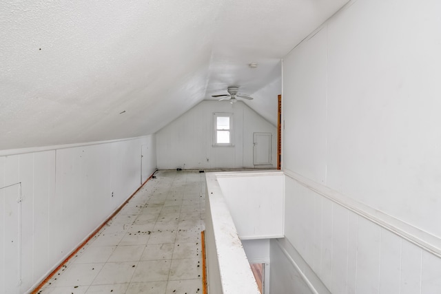 bonus room featuring a textured ceiling, ceiling fan, and lofted ceiling