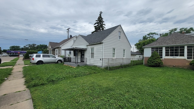 view of side of home featuring a lawn