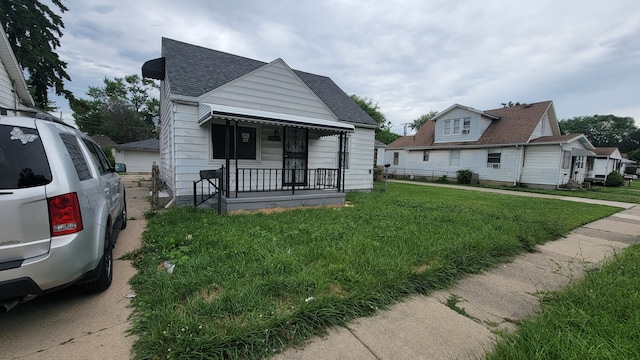 bungalow-style home featuring a front yard and a porch