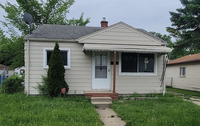 bungalow-style house with a front yard