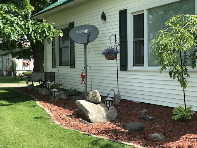 view of side of home featuring a yard