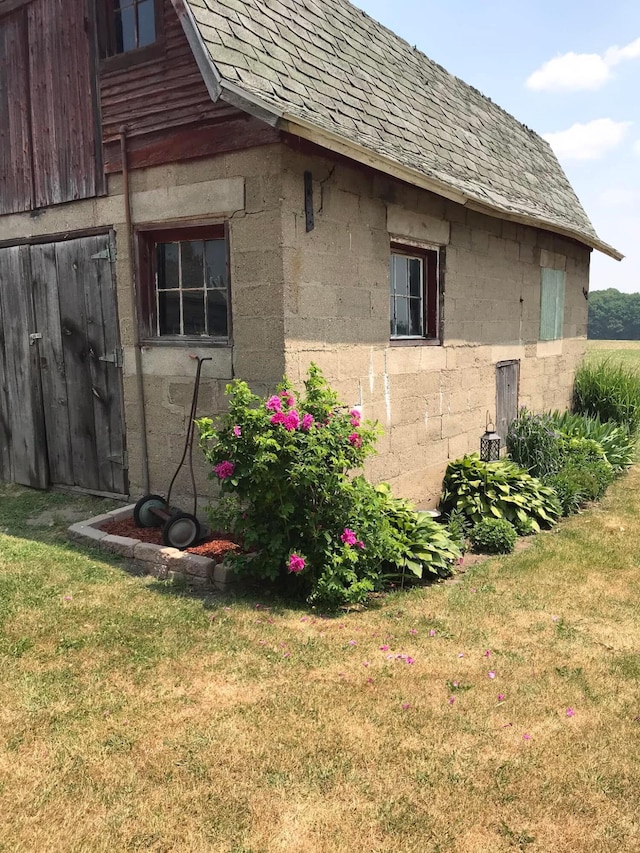 view of side of property with a yard