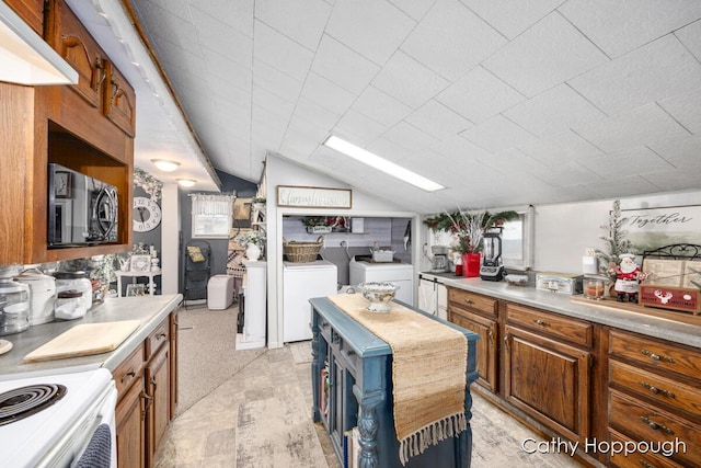 kitchen featuring separate washer and dryer and lofted ceiling