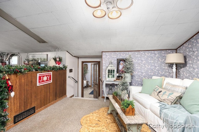 living room featuring carpet and crown molding