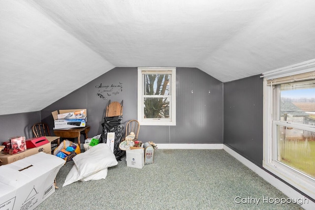 bonus room with carpet floors, a wealth of natural light, and vaulted ceiling