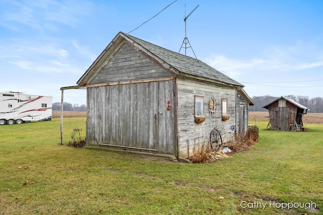 view of outbuilding with a lawn