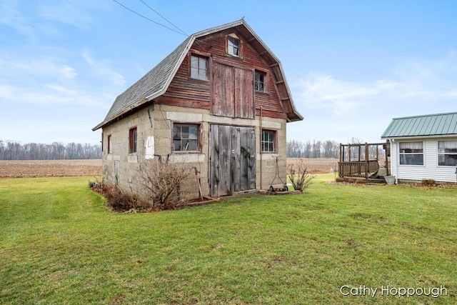 view of outbuilding with a lawn