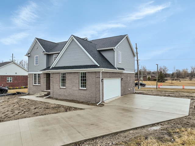 view of front of home with a garage, roof with shingles, concrete driveway, and brick siding